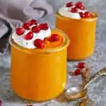 Delicious, dairy-free, and easy squash pudding in two individual glass jars ready to be enjoyed.