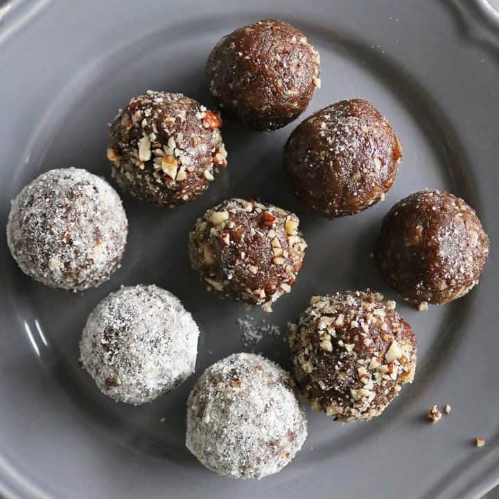 3 ingredient date energy balls rolled in coconut powder, chopped pecans and plain.