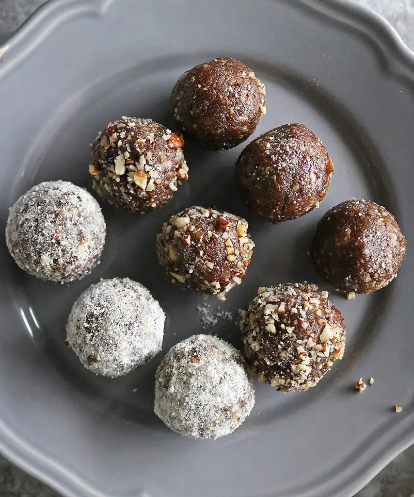 3 ingredient date energy balls rolled in coconut powder, chopped pecans and plain.