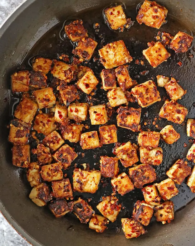 Sautéing tofu with maple chili marinade