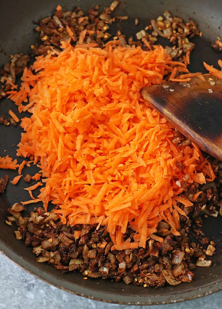 Sautéing carrot with spices onion, ginger, and garlic to make this easy healthy side dish