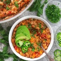 Enjoying a bowl of vegetarian enchilada quinoa with toppings