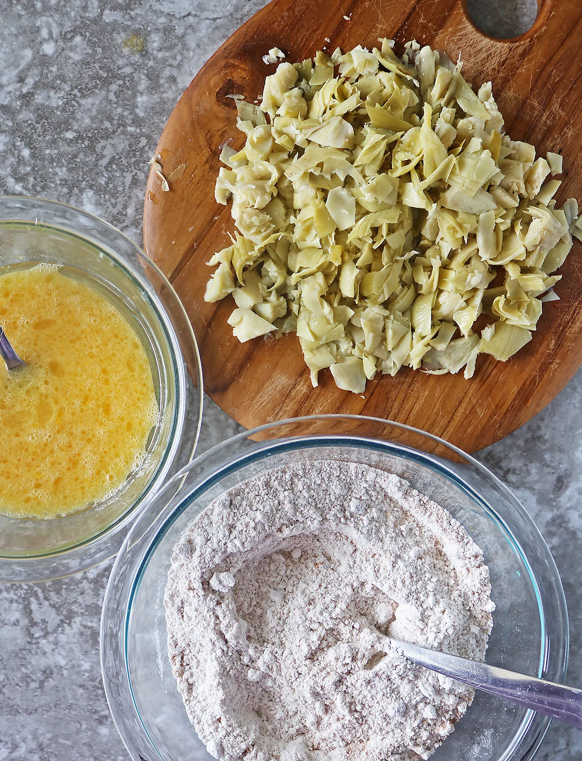 Mixing together dry ingredients and wet ingredients and artichokes