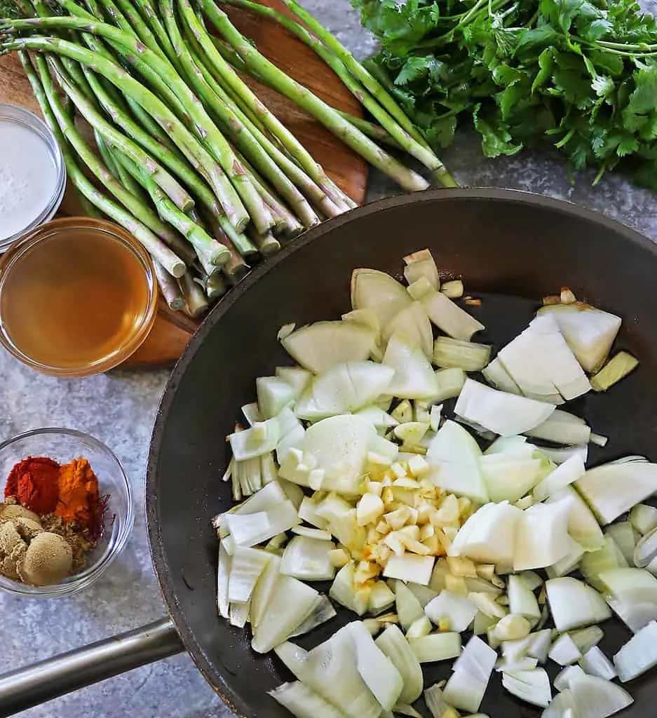 Sautéing onions garlic ginger soon to be followed by spices coconut milk and veg stock