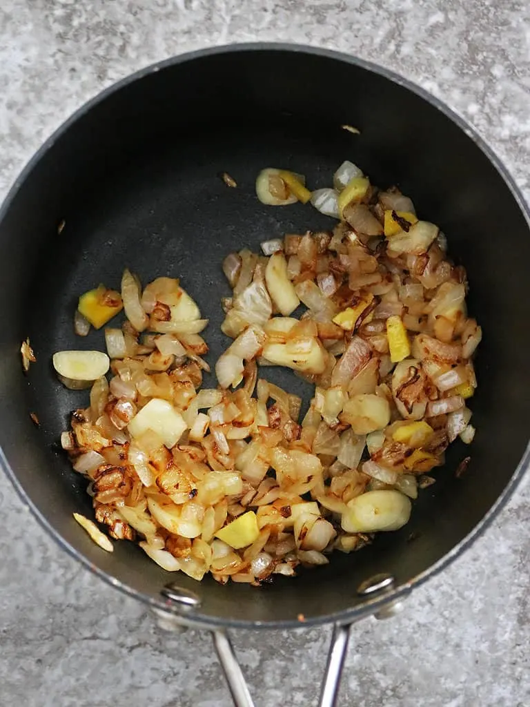 Sautéing onion ginger garlic to make pineapple chutney