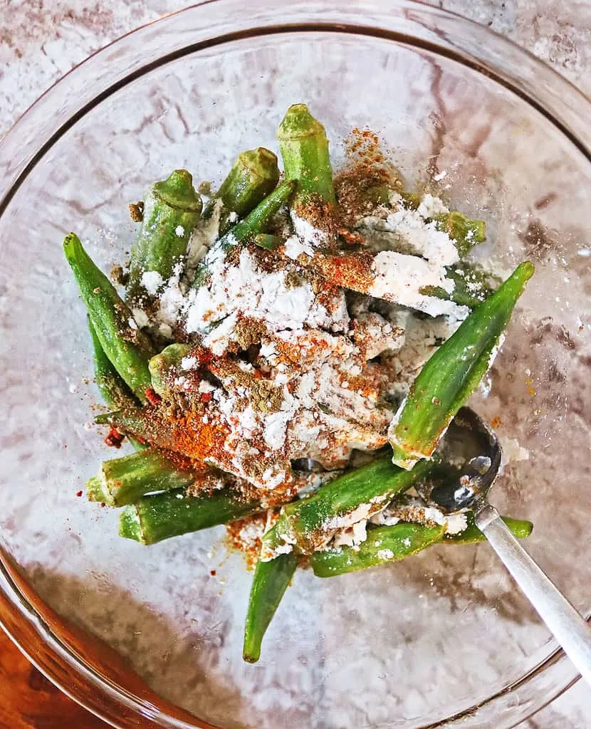 Adding in spices and tapioca flour to frozen okra