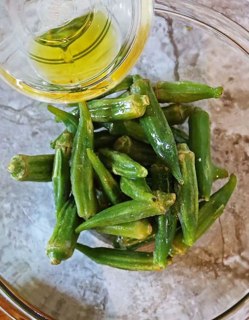 Adding oil to rinsed frozen okra