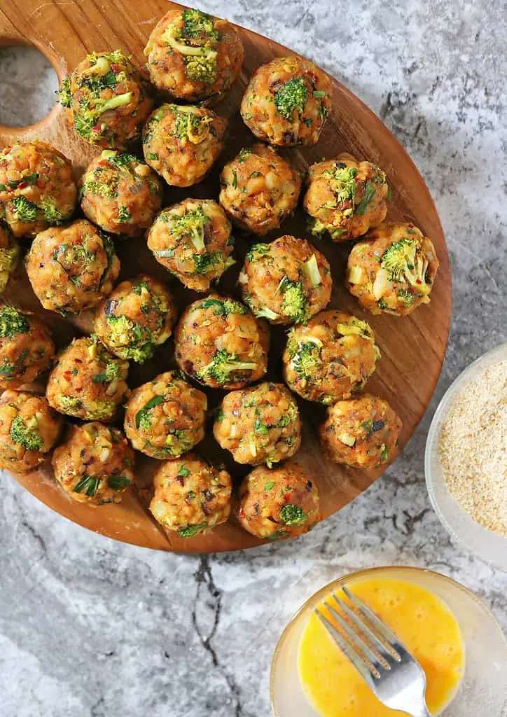 Getting ready to dunk croquettes in egg wash and breadcrumbs