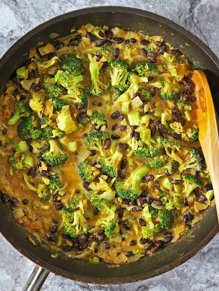 Making a hearty tasty curry with broccoli and black beans