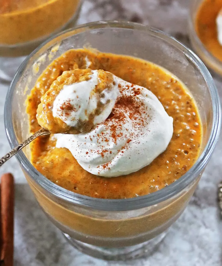 Taking a spoonful of a Healthy pumpkin spice chia pudding recipe
