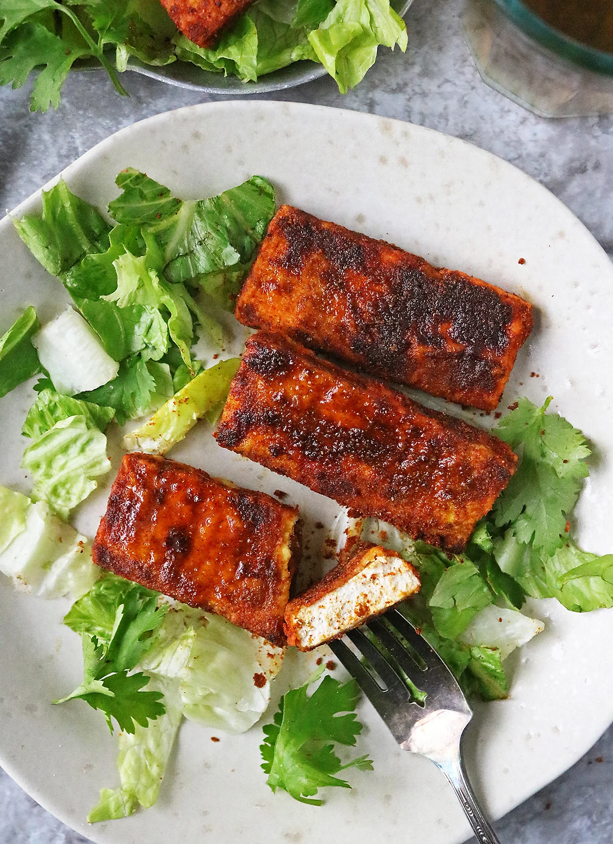 Easy Vegetarian baked tofu on a plate with a fork