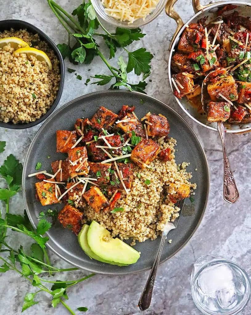 Marry-Me-Tofu with Zaatar Lemon Quinoa Dinner on marble background