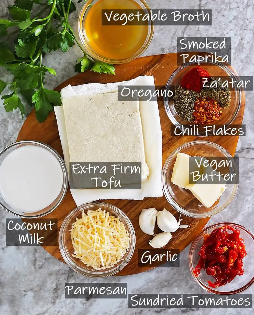 11 ingredients to make marry me tofu on a wooden platter.