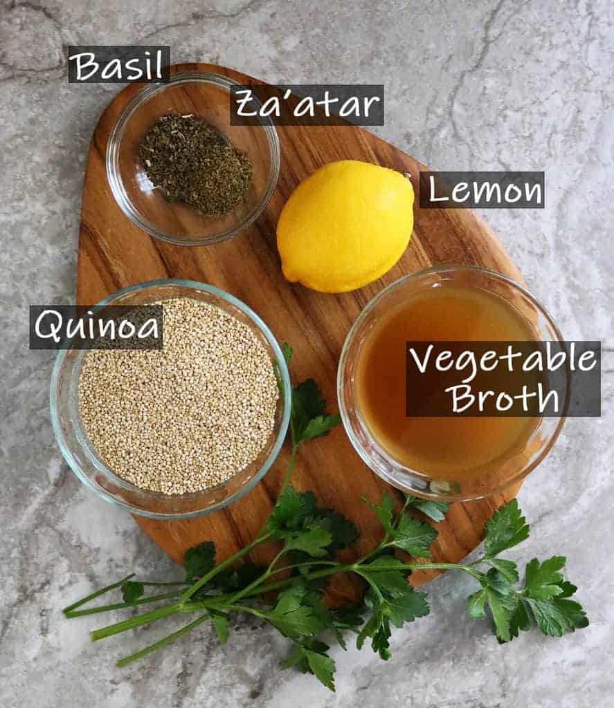Ingredients to make lemon zaatar quinoa on a wooden platter.