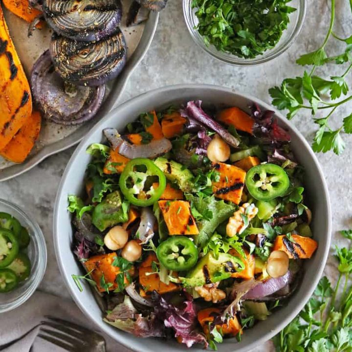A bowl with a healthy sweet potato summer salad along with grilled sweet potato, grilled avocado, and grilled onions on a tray.