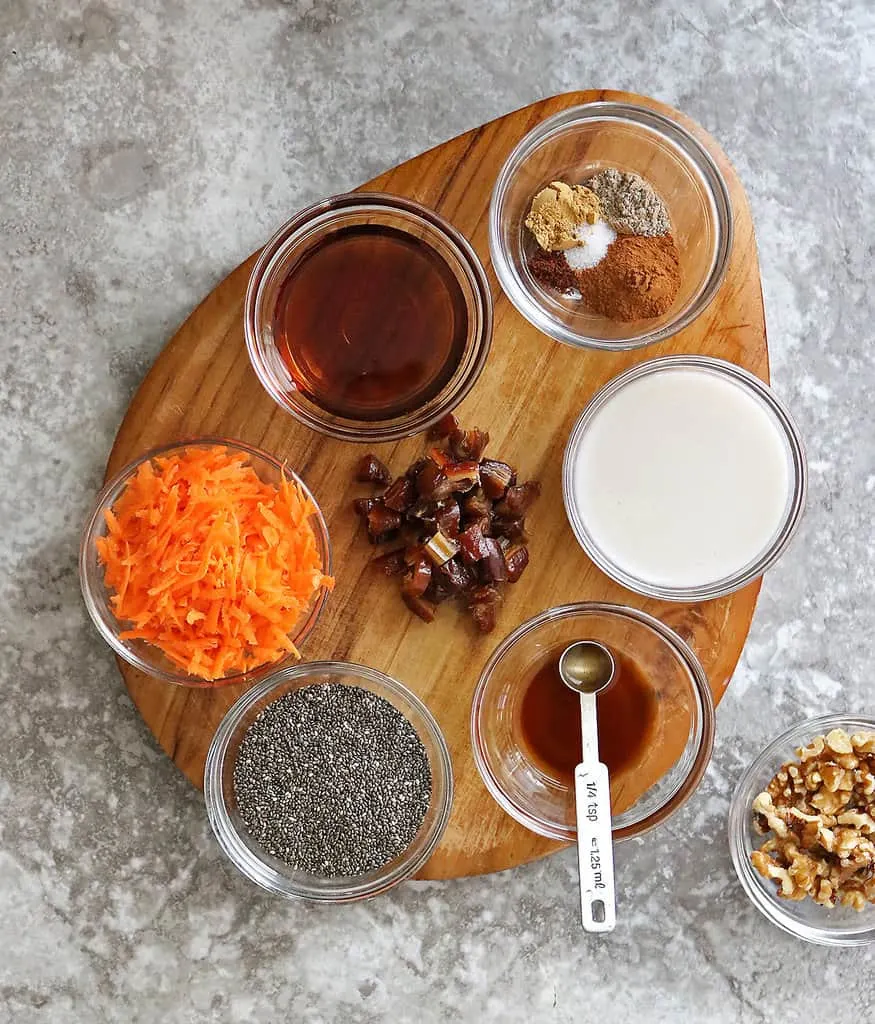 Ingredients to make carrot cake chia pudding on a board.