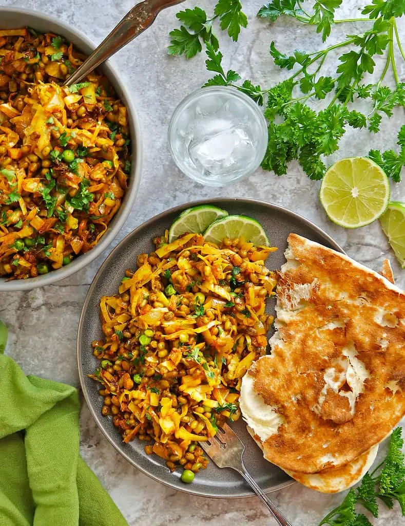 Easy mung bean cabbage saute with some naan on a flatlay.