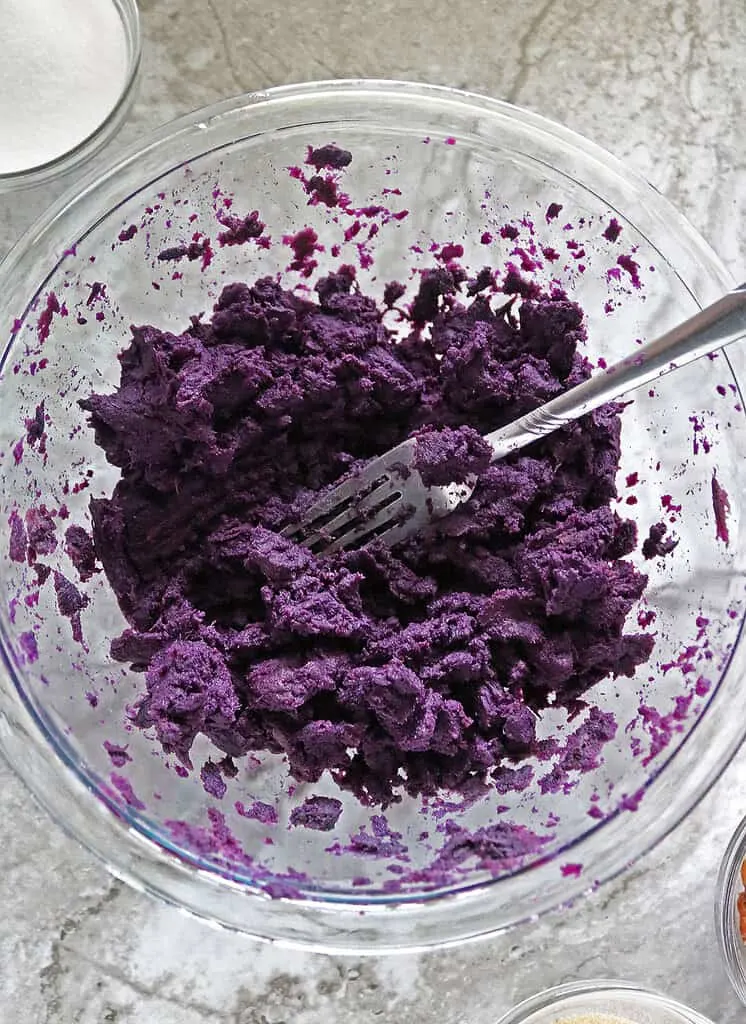 Mashing baked purple sweet potatoes