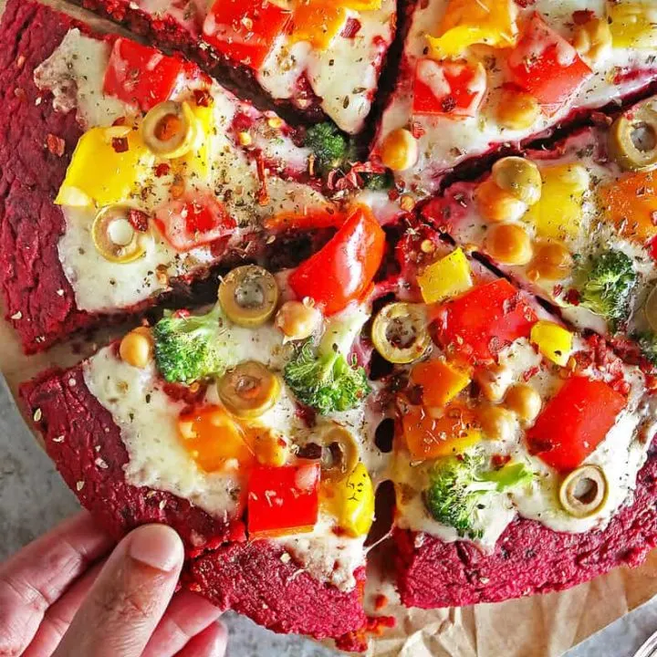 Tasty gluten-free beet pizza crust loaded with cheese and veggies.