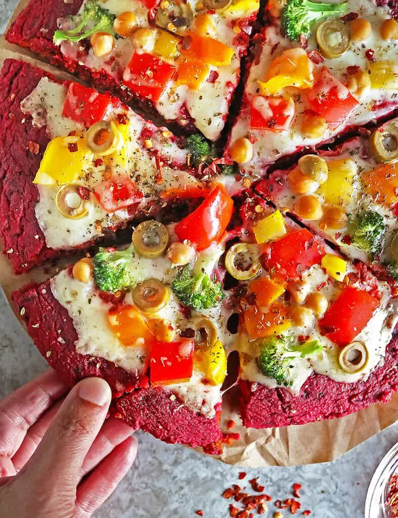 Tasty gluten-free beet pizza crust loaded with cheese and veggies.