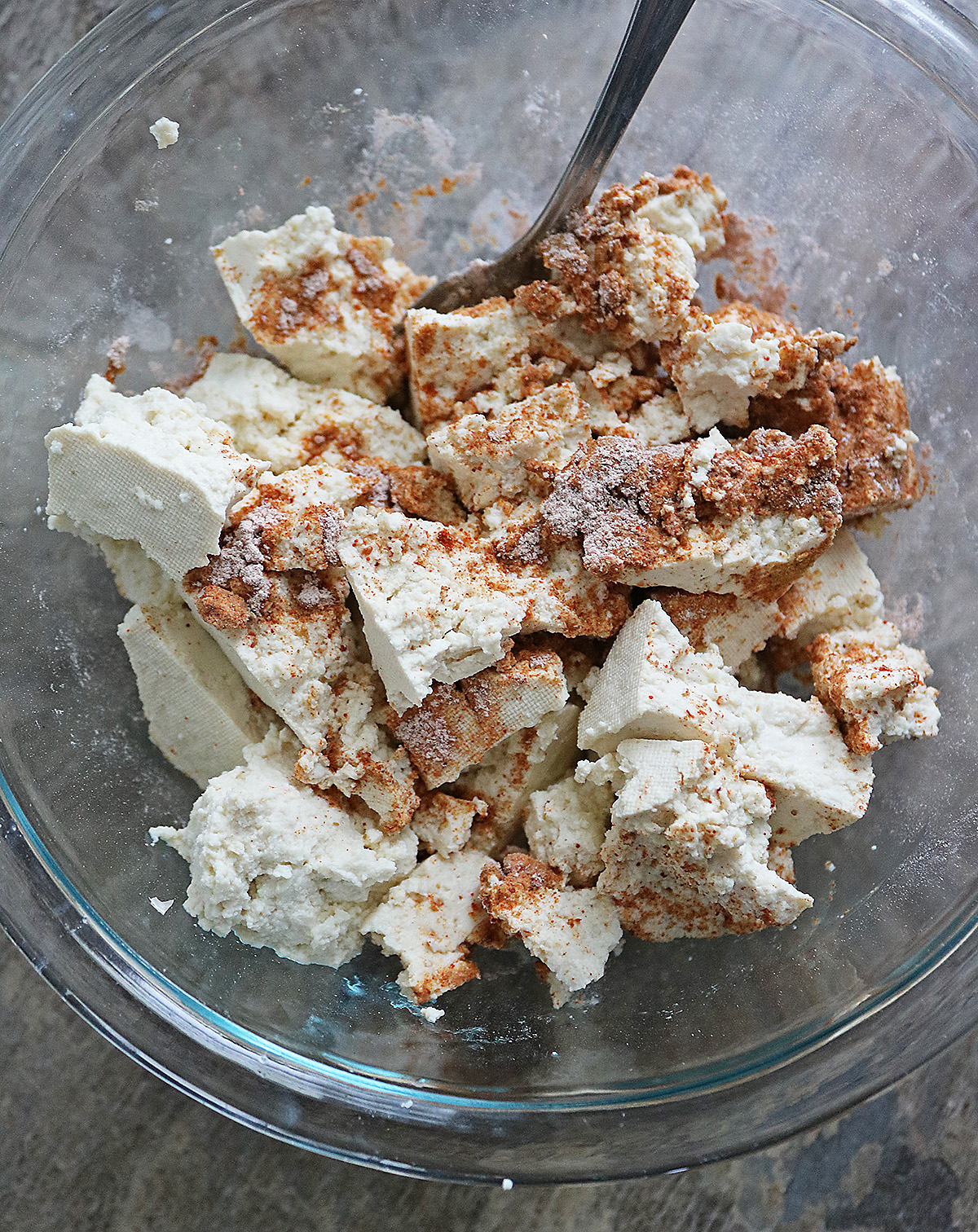 Mixing tofu with arrowroot spice mix