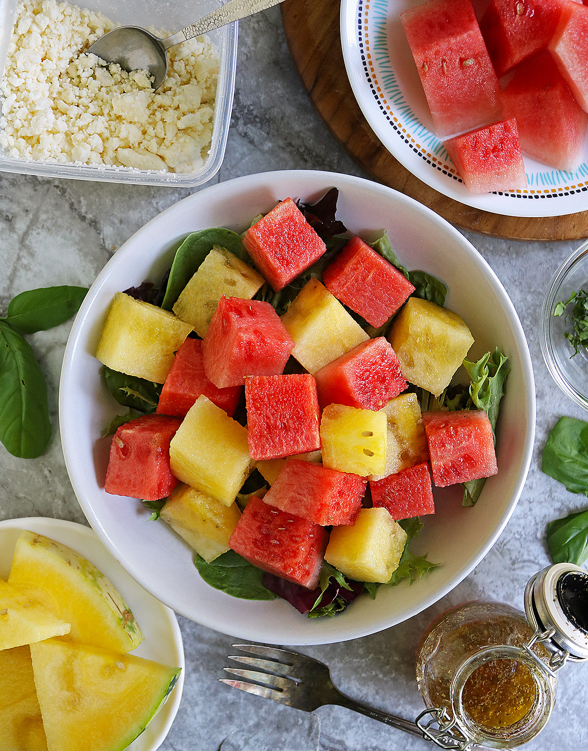 Beautiful red watermelon and yellow watermelon cubes in a large bowl.