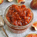 Easy and delicious fig chutney ready in 25 minutes, in a jar on a grey table.