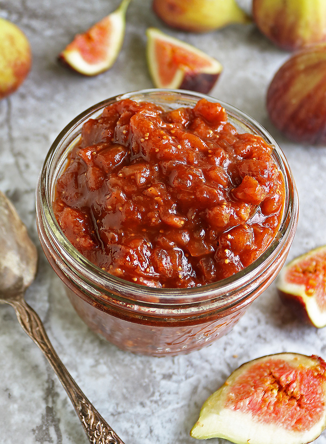 Easy and delicious fig chutney ready in 25 minutes, in a jar on a grey table.