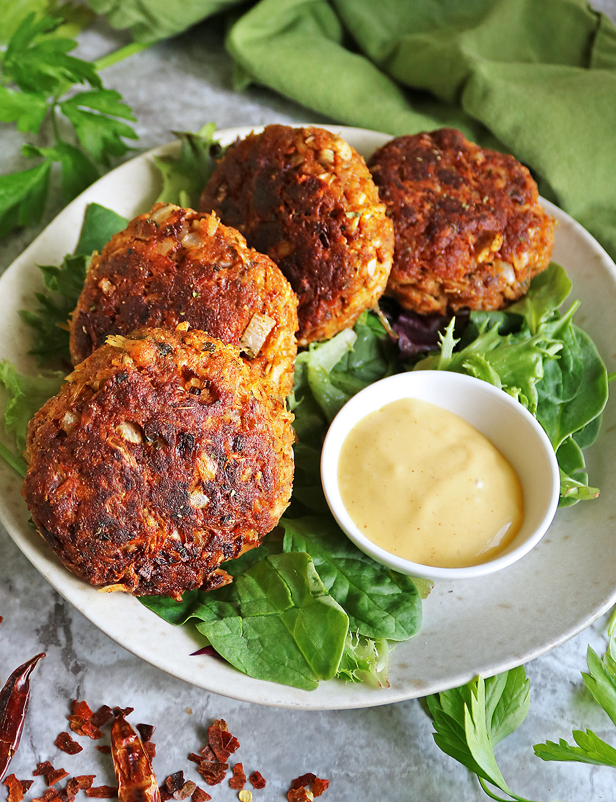 Easy Spicy chicken cakes on a bed of greens.