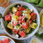 Honey Orange Watermelon Salad with feta and fresh basil in a large salad bowl.