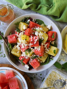 Honey Orange Watermelon Salad with feta and fresh basil in a large salad bowl.