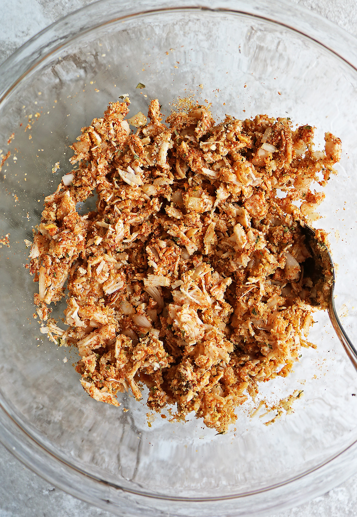 Mixing all the ingredients together to form into cakes.