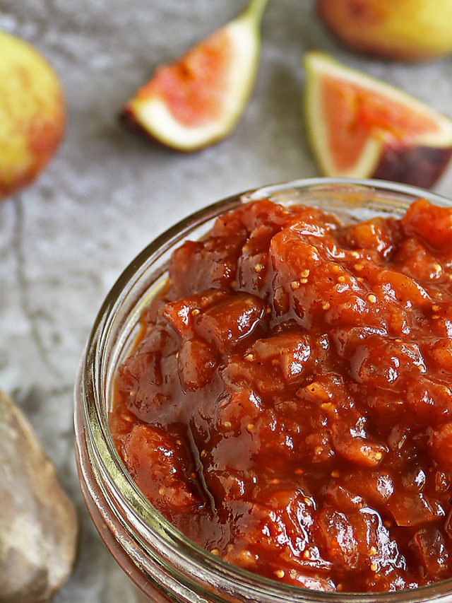 Easy and delicious fig chutney ready in 25 minutes, in a jar on a grey table.