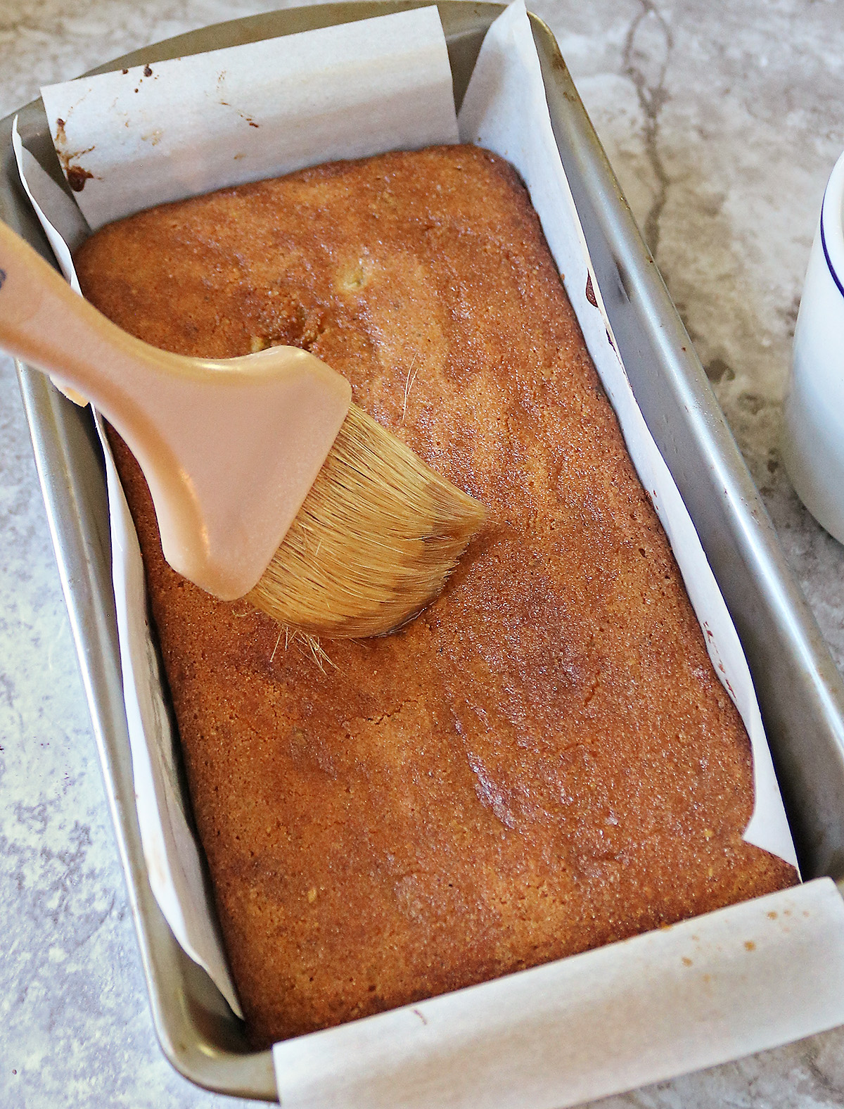 Brushing the top with lemon simple syrup