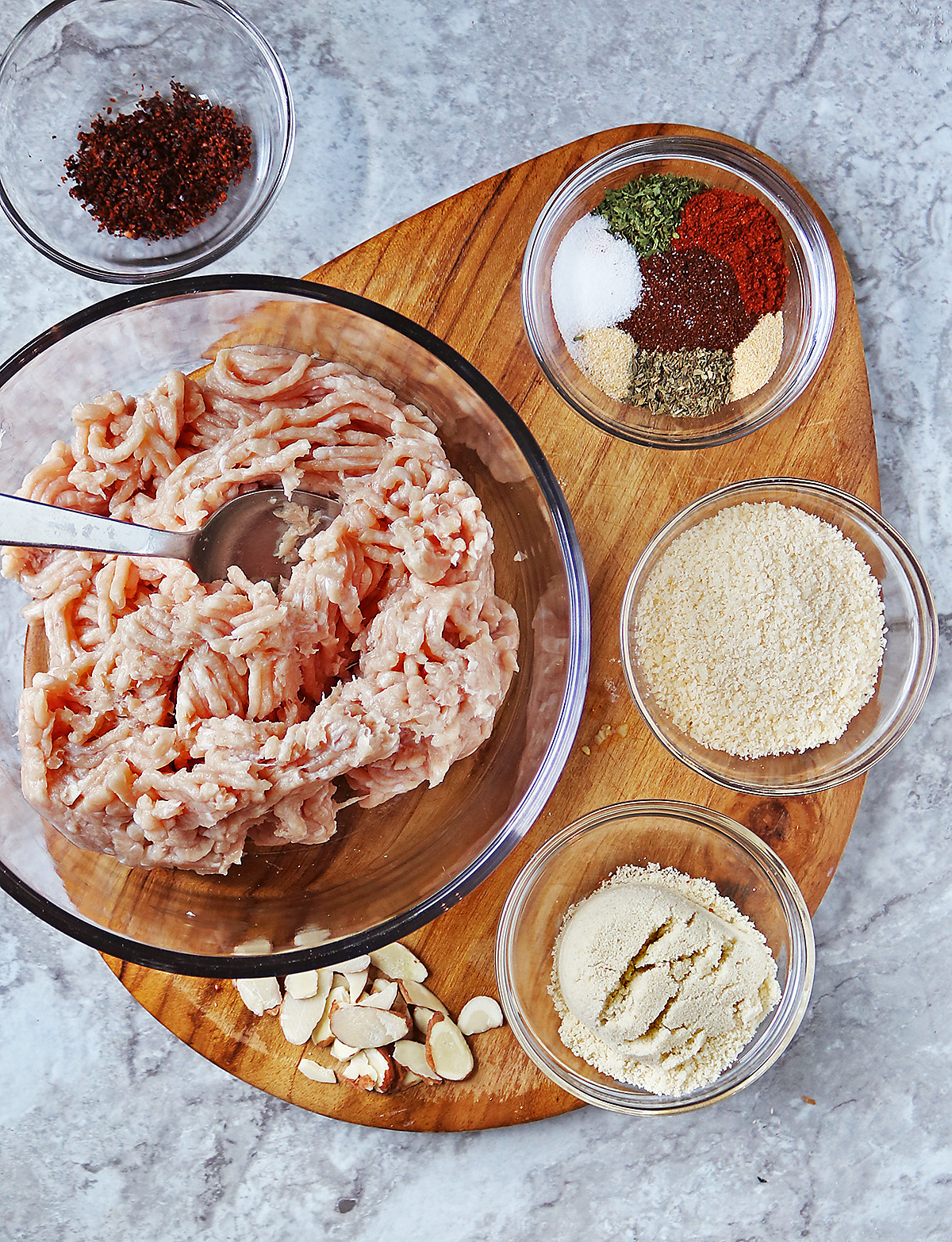 12 Ingredients to make chicken fingers on a cutting board.