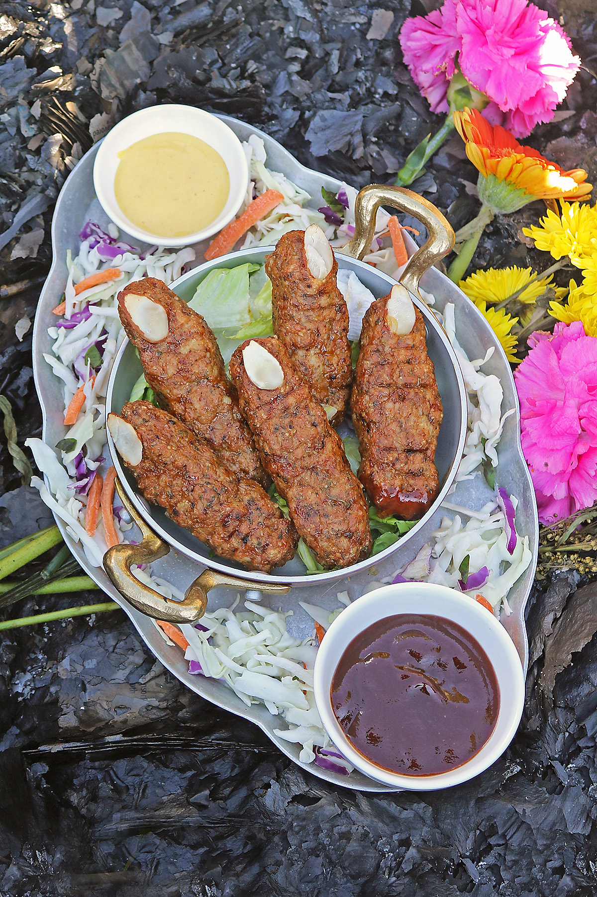 Platter of spooky chicken fingers on ashes.