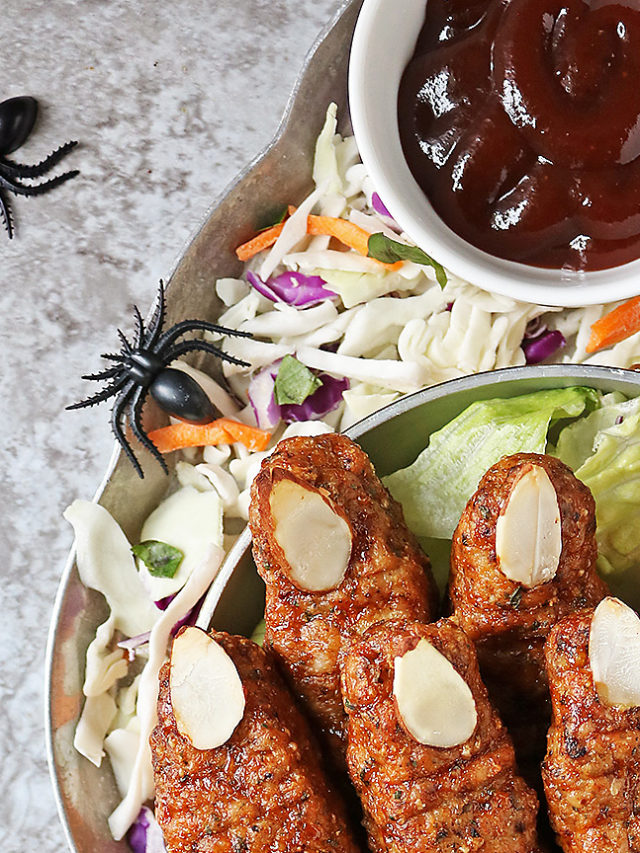 Spooky Chicken Fingers for Halloween on a silver platter with bbq sauce and honey mustard sauce.