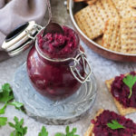 Easy purple sweet potato chutney in a small jar with crackers around.