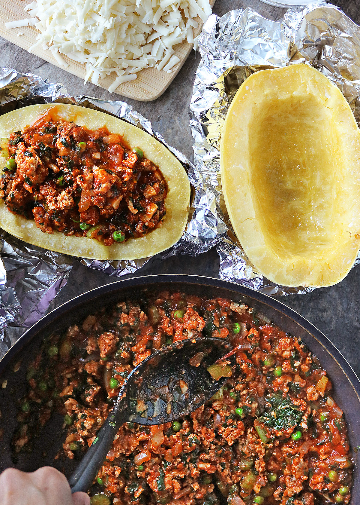 Adding chicken and veggies in tomato sauce to spaghetti squash