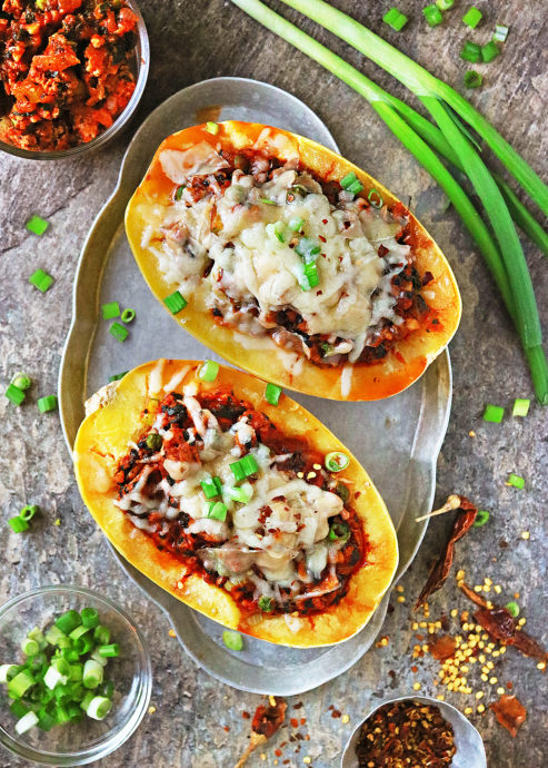 Easy Chicken Stuffed Spaghetti Squash with chicken and vegetables cooked in a delicios spiced tomato sauce, then topped with cheese and baked until cheese is bubbly.