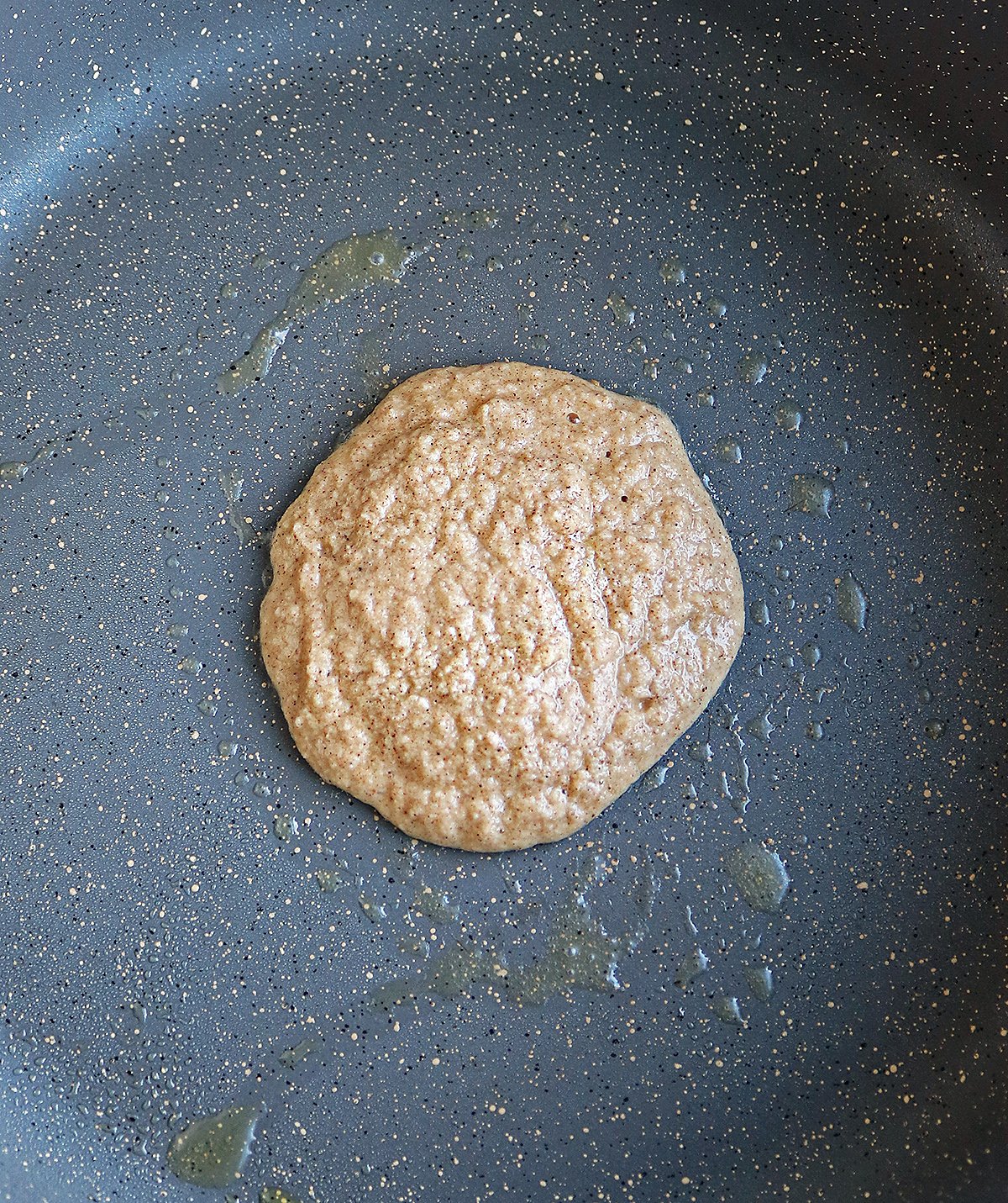 Making almond flour pancakes in a large skillet