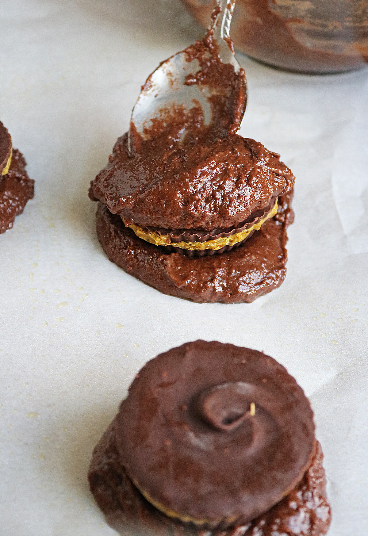 Putting more muffin top batter over the Dubai Chocolate Cup