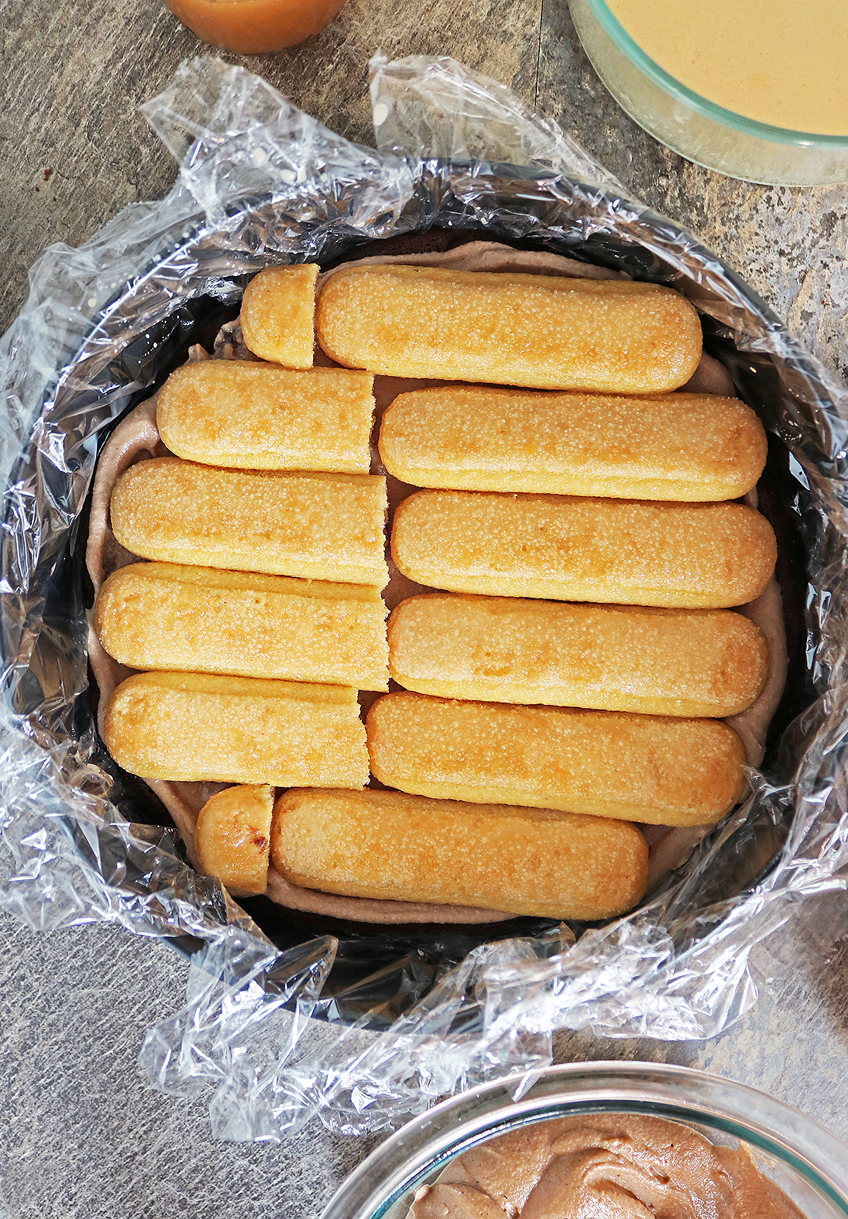 Adding dulce de leche soaked ladyfingers on top of chocolate mousse