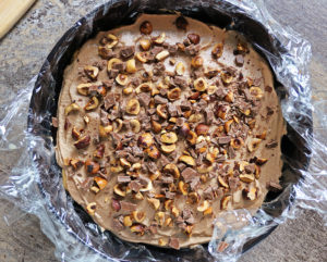 Layering chocolate bits with the hazelnuts over chocolate mpusse over dulce de leche soaked ladyfingers 2