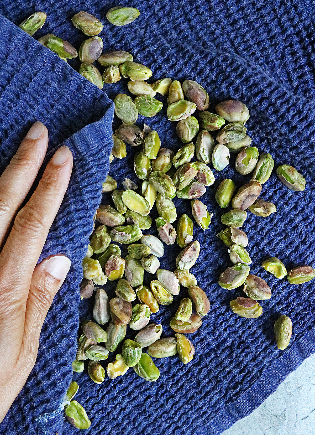 Rub pistachios with a towel