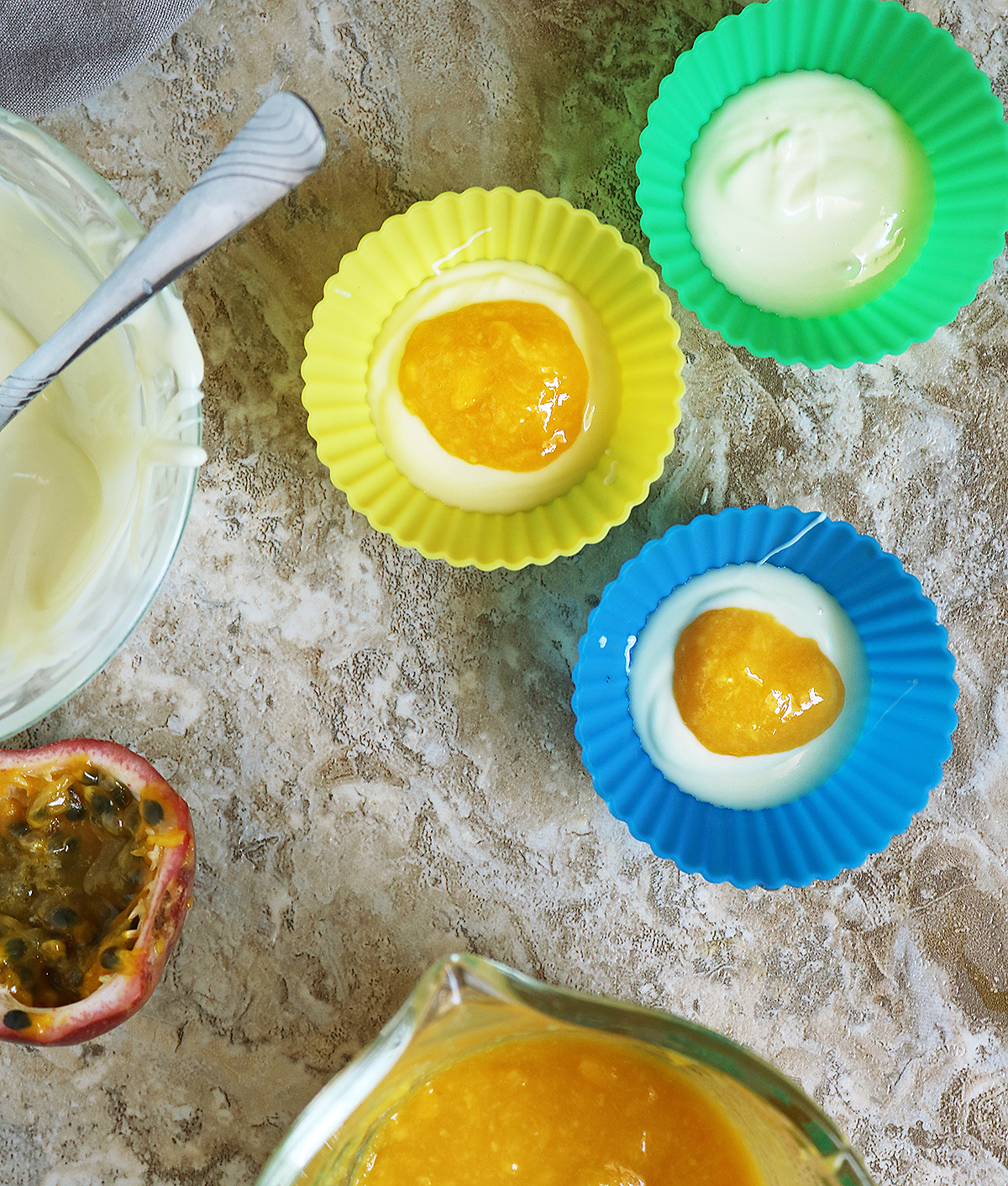 Step two adding mango puree on top of the white chocolate layer