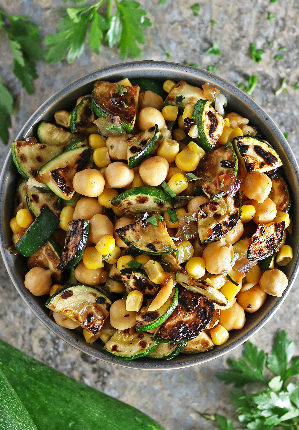 5-ingredient zucchini onion salad in a bowl with some parsley.