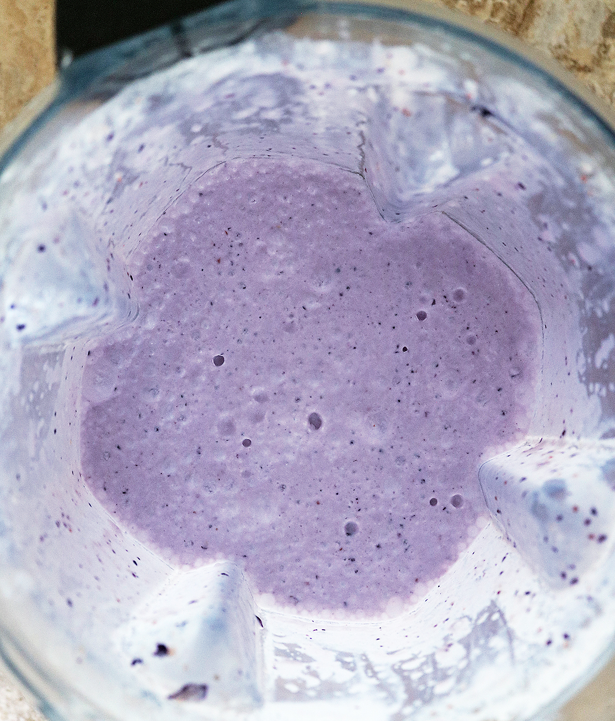 Blending together ingredients to make dairy free blueberry lemon ice cream and popsicles