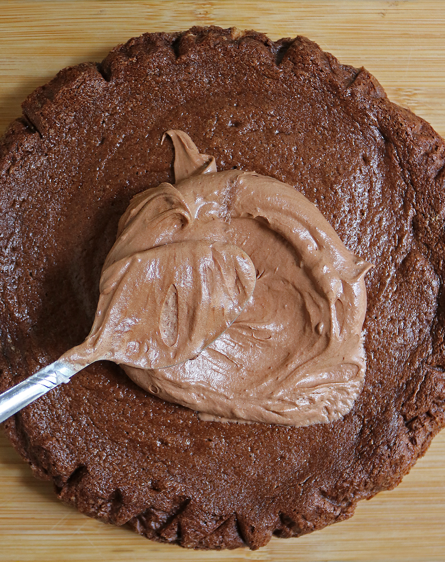 Spreading 2 ingredient frosting on 2 ingredient cake