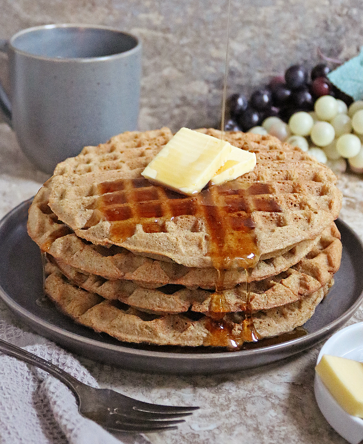 A stack of almond flour waffles with keto syrup